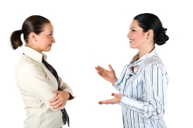 Two business women. One is sharing her idea enthusiastically, the other one is a little skeptical.