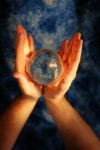 Two hands holding a crystal ball symbolising looking into the future