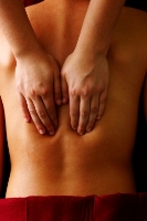 Hands massaging a man's back to symbolise touch.