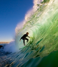 Surfer in challenging wave to symbolise the risk taking  of intrapreneurship