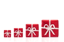 Red wrapped gifts increasing in size symbolising small innovation opportunities growing into large innovation opportunities.