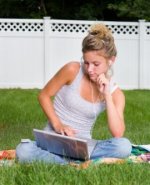 Girl using laptop and MP3 player symbolising how new technologies present risks and opportunities to business models